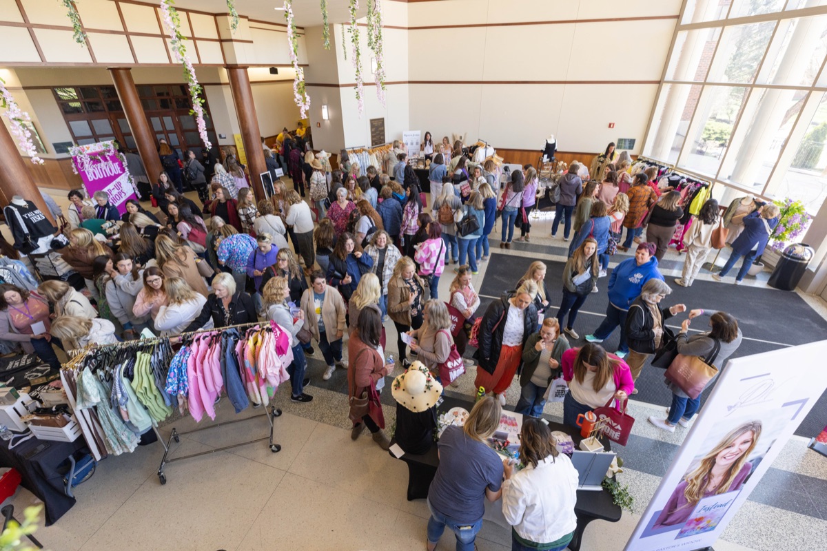 Women exploring the MORE conference boutique